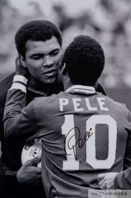 A large black and white portrait photograph of Pele embracing Muhammad Ali, 
 wearing his famous Santos No.10 shirt, signed on the front in black mark