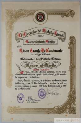 A scroll of Merit presented to Pelé by the Government of Caracas in 1989 for his achievements in sports. 
 The scroll is housed in a blue tube 22 1/4 