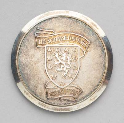 Silver Scottish Football Association medal awarded to Tommy Docherty for making 25 international appearances for Scotland,
 fully inscibed obverse and