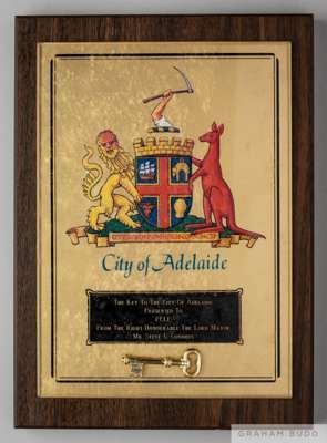 An Adelaide, Australia, Key to the City plaque presented to Pelé on July 5, 1988.
 The gold tone plaque is affixed to a wood base. The plaque features