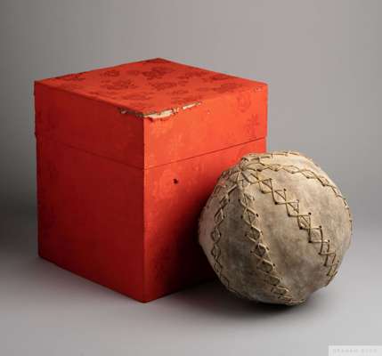 A hand stitched, rawhide cuju football presented to Pelé on a visit to China
 the football is housed in a red wooden box and sits on gold satin inside