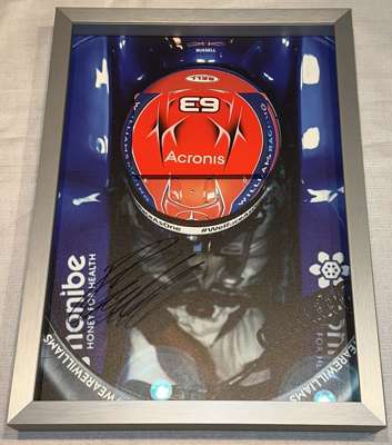 George Russell (UK) signed limited edition Williams 2020 framed replica helmet print, 
 including a part of his helmet metal plate in the frame. Signe