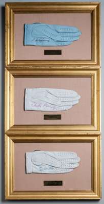 Three international Major winner's signed golf gloves,
 each glove mounted, glazed and framed with engraved players name, signed in black, blue and pi