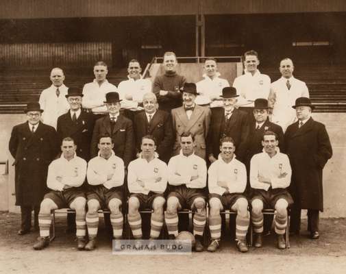 Official photograph of the Preston North End 1938 F.A. Cup winning team and club officials,
 posed standing and seated in front of the stand, photogra