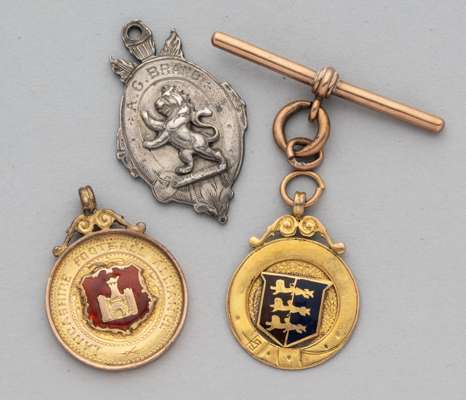 Three football medals, from 1905 to late 1920s, 
 comprising silver medal the obverse inscribed A.G. BRAND, the reverse inscribed FOOTBALL, 1905, stam
