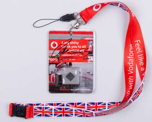 Nigel Mansell Signed McLaren Factory Pass With a Piece of 2011 McLaren Car Part