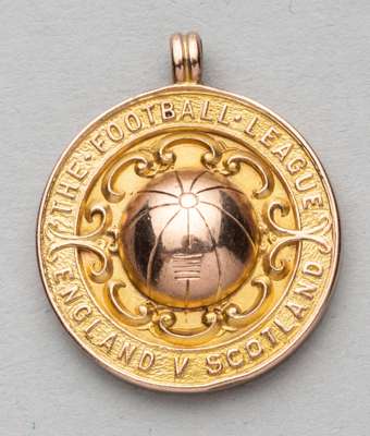 The Football League England v Scotland representative medal awarded to H. Nuttall,
 obverse with a football in relief surrounded by THE FOOTBALL LEAGU
