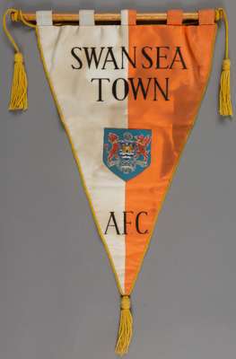 Swansea Town match pennant,
 large pennant on wooden hanging pole with gold trimming, the pennant is approx. 12 by 24in. to bottom tassel and is in tw