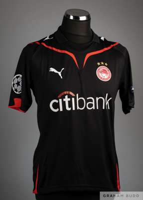 Christian Ledesma black no.28 Olympiakos short sleeved shirt, 2010, 
 Puma, size Medium with V neck, Club badge embroidered on the front along with th