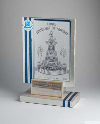 A silver tone plaque trophy presented to Pelé by the Santos City neighbourhood of Gonzaga 
 to commemorate the centennial of its founding.14 3/4 by 9 