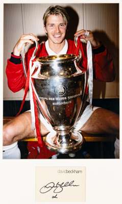 Two David Beckham signed colour photographs,
 the first featuring David Beckham in Manchester United kit holding the 'UEFA Coupe des Clubs Champions E