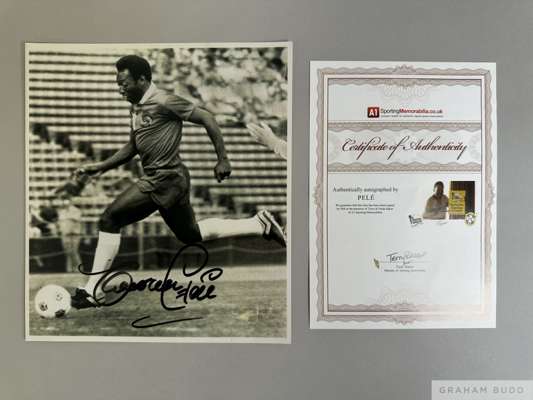 A black and white autographed photograph of Pele in Cosmos strip
 with COA from Sporting Memorabilia.co.uk signed by Terry Baker