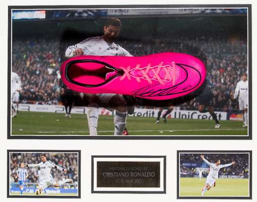 A Cristiano Ronaldo signed Real Madrid football boot display, comprising a hyper-pink & black Nike Mercurial Victory right-foot boot signed by Ronaldo