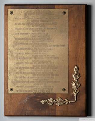 A gold tone engraved plaque owned by Pelé, 
 mounted to a wood backing, featuring a poem titled "The Great Pelé."12 by 9 inches

 PROVENANCE: The Pele