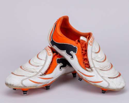 Pair of white and orange football boots