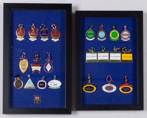 A pair of framed displays of metal & enamel racecourse badges