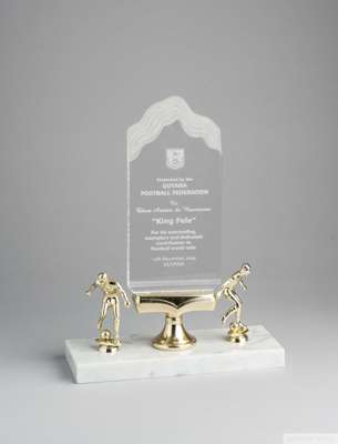 An acrylic trophy mounted on a marble base, presented to Pelé by the Guyana Football Federation commemorating his visit,
 the trophy features two gold