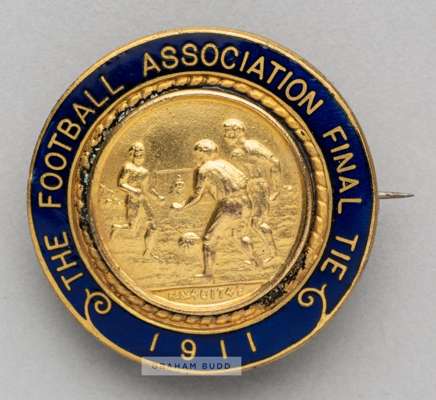 1911 F.A.Cup Final badge issued to the F.A. official Charles James Hughes (1853-1916),
 in gilt metal and blue enamel the centre with a football match