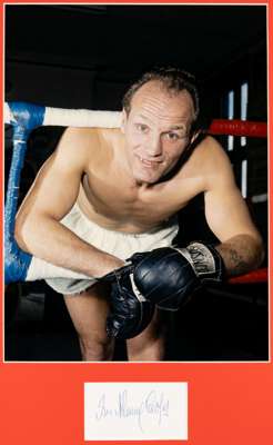 Henry Cooper signed colour photograph display, 
 the image featuring Henry Cooper between the ropes, mounted above his autograph in blue pen, glazed a