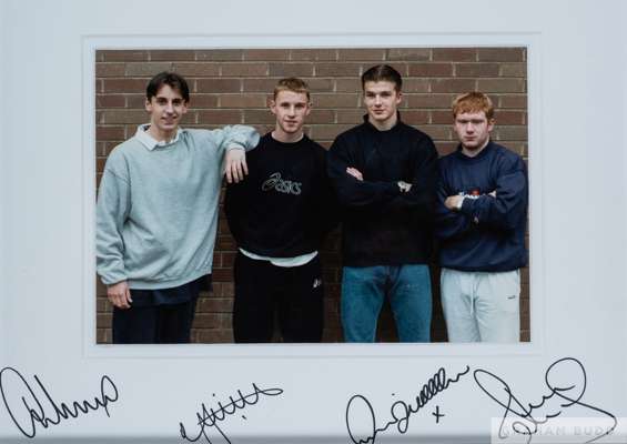 A colour photograph of a youthful Gary Neville, Nicky Butt, David Beckham and Paul Scholes
 the print autographed by all the above players, framed, 35