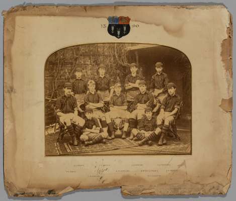 Period photograph of the Eton College football team in 1890,
 sepia-toned, painted with college crest dated 1890, hand written player identification b