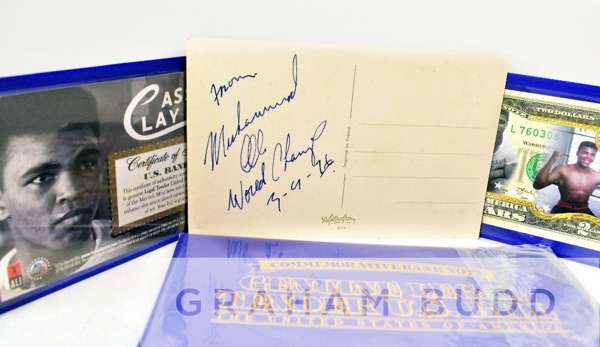Boxing: Muhammad Ali World Champ signed 5.5 x 3.5in. postcard, 
 autograph is dated 3-9-76, comes complete with two genuine US dollar bills in wallets