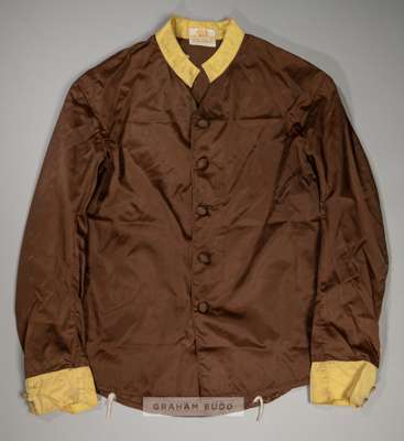 A set of Colonel William H Whitbread chocolate racing silks, 
 with yellow collar and cuffs, bearing maker label for GEORGE PARKER & SONS LTD, LONDON,