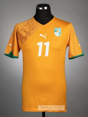Didier Drogba orange Ivory Coast no.11 home jersey, circa 2010,
 Puma, short-sleeved with PUMA sleeve logo's, embroidered country badge and sponsor lo