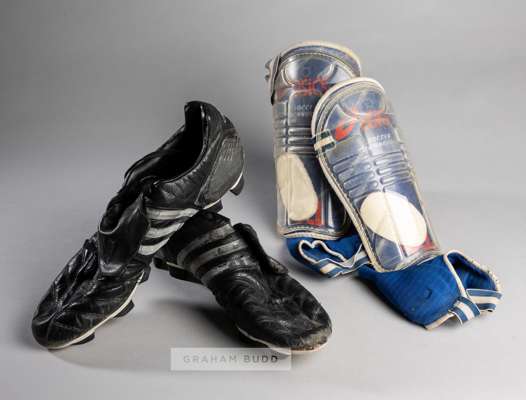 Peter Crouch Adidas Traxion football boots,
 the black and silver boots bearing lettering PC to the soles, sold together with a pair of Asics shin pad