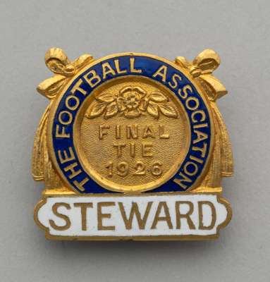 A gilt-metal and enamel 1926 F.A. Cup Steward's badge, 
 the obverse inscribed THE FOOTBALL ASSOCIATION, FINAL TIE 1926 STEWARD with brooch fitting