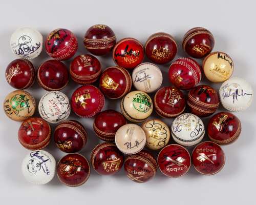 Thirty-three various autographed cricket balls