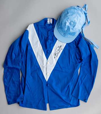 Maktoum Al Maktoum racing silks signed by the late Lester Piggott,
 bearing marker's neck label for Gibsons Saddlers. Newmarket, royal blue jacket wit