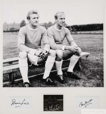 Large b&w autographed photograph of Bobby Charlton and Denis Law, 
 taken during a break in a training season with original glass of the image, 1960s,